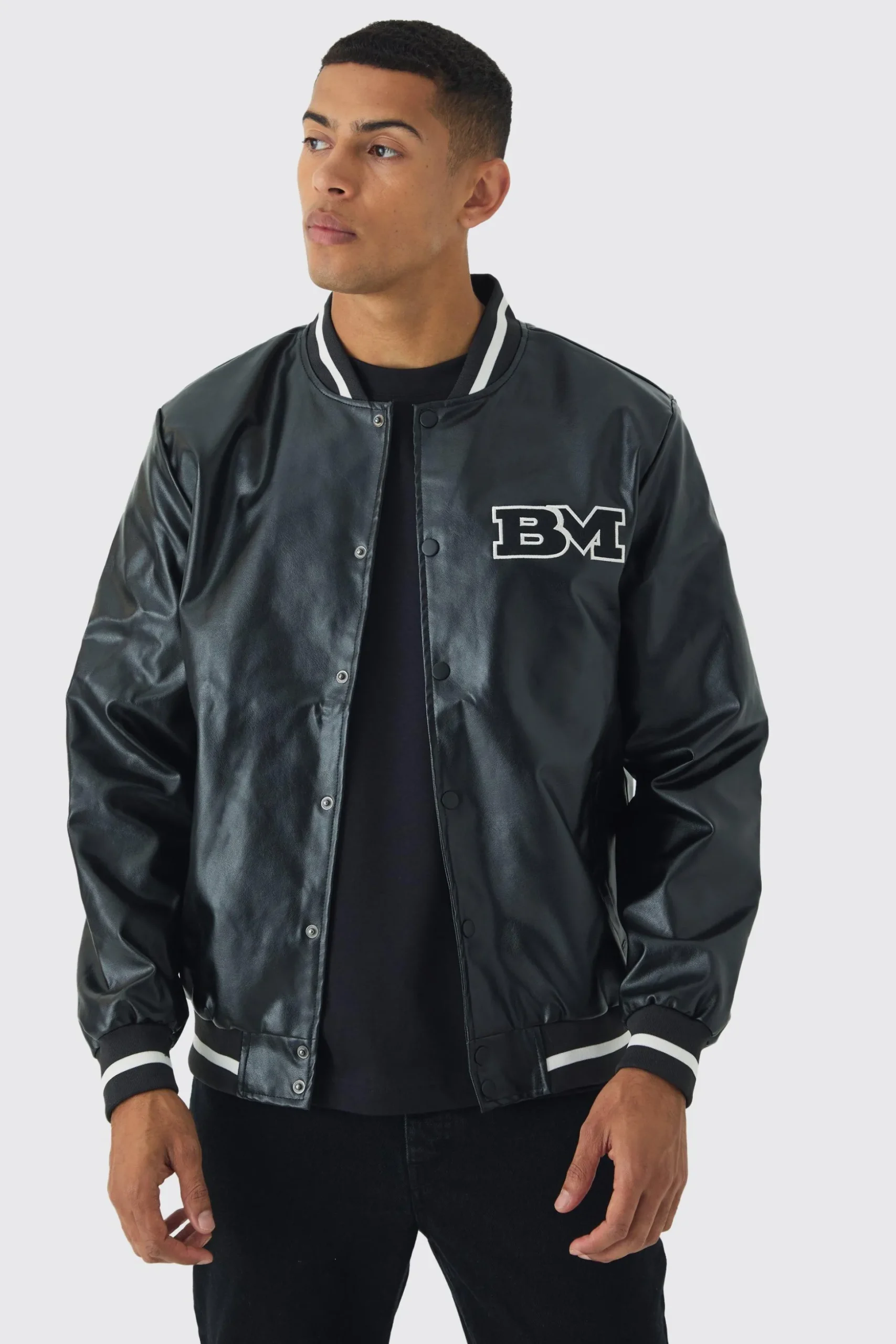 PU Badge Varsity Jacket In Black | BoohooMAN UK